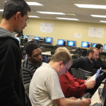 Students get Black Friday computer imaging instructions for Simon property group project from Living Lab staff member Nick Novotny.